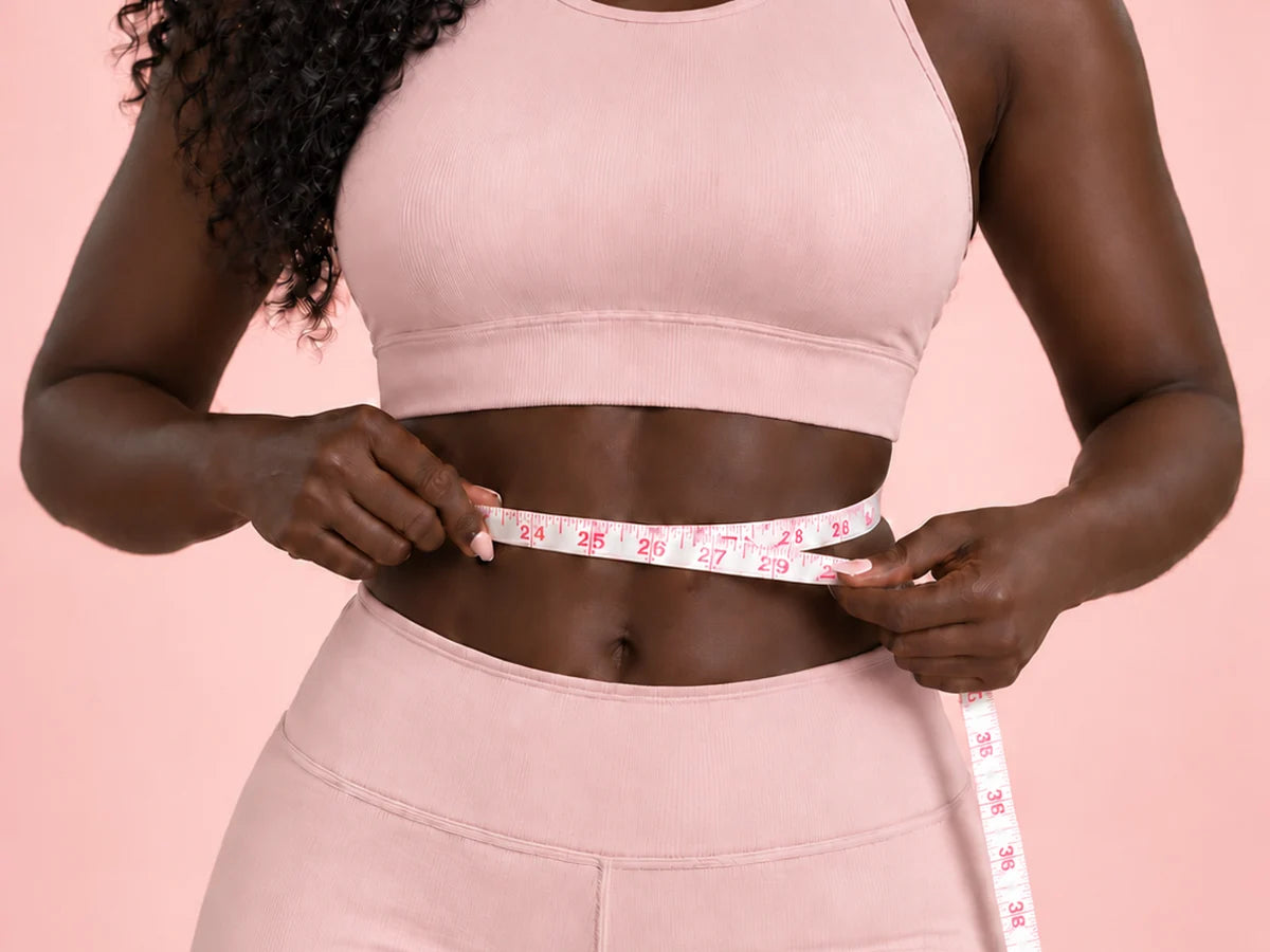A woman measuring her waist